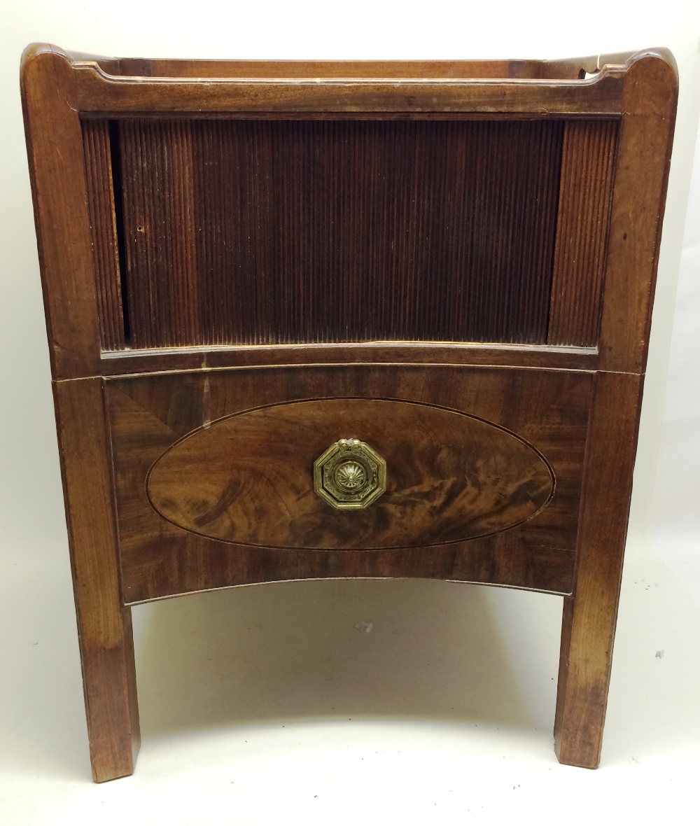 A Sheraton period mahogany bedside night commode the galleried top, the concave front with a tambour