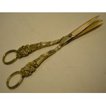 A pair of Regency silver gilt grape shears, having reeded and grapevine handles with ring terminals.