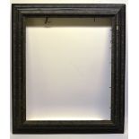 A nineteenth century continental ebonized wood picture frame, with cast composition crinkle