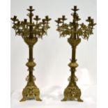 A pair of nineteenth century Medieval Revival style seven light candelabra, the berried foliage