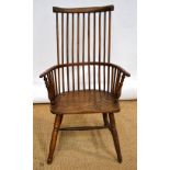 An early nineteenth century ash high comb back Windsor armchair with an elm seat on turned legs