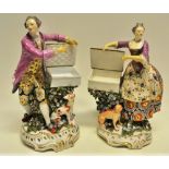 A pair of eighteenth century Derby porcelain figures salts, the gentleman wearing a mauve coat and