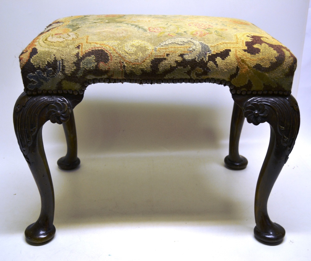 A George II style stool, the rectangular stuffed over seat covered floral needlework with brass