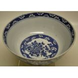 A Chinese nineteenth century porcelain punch bowl, decorated blue and white panels of a bird perched