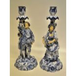 A pair of late nineteenth century Volkstedt blue and white porcelain candlesticks, the everted stems