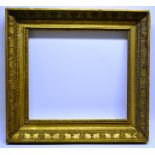 An early nineteenth century gilt picture frame with Classical Revival gesso decoration, to take a