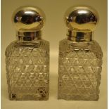 A pair of late Victorian hobnail cut glass square scent decanters, with hinged silver covers, gilded