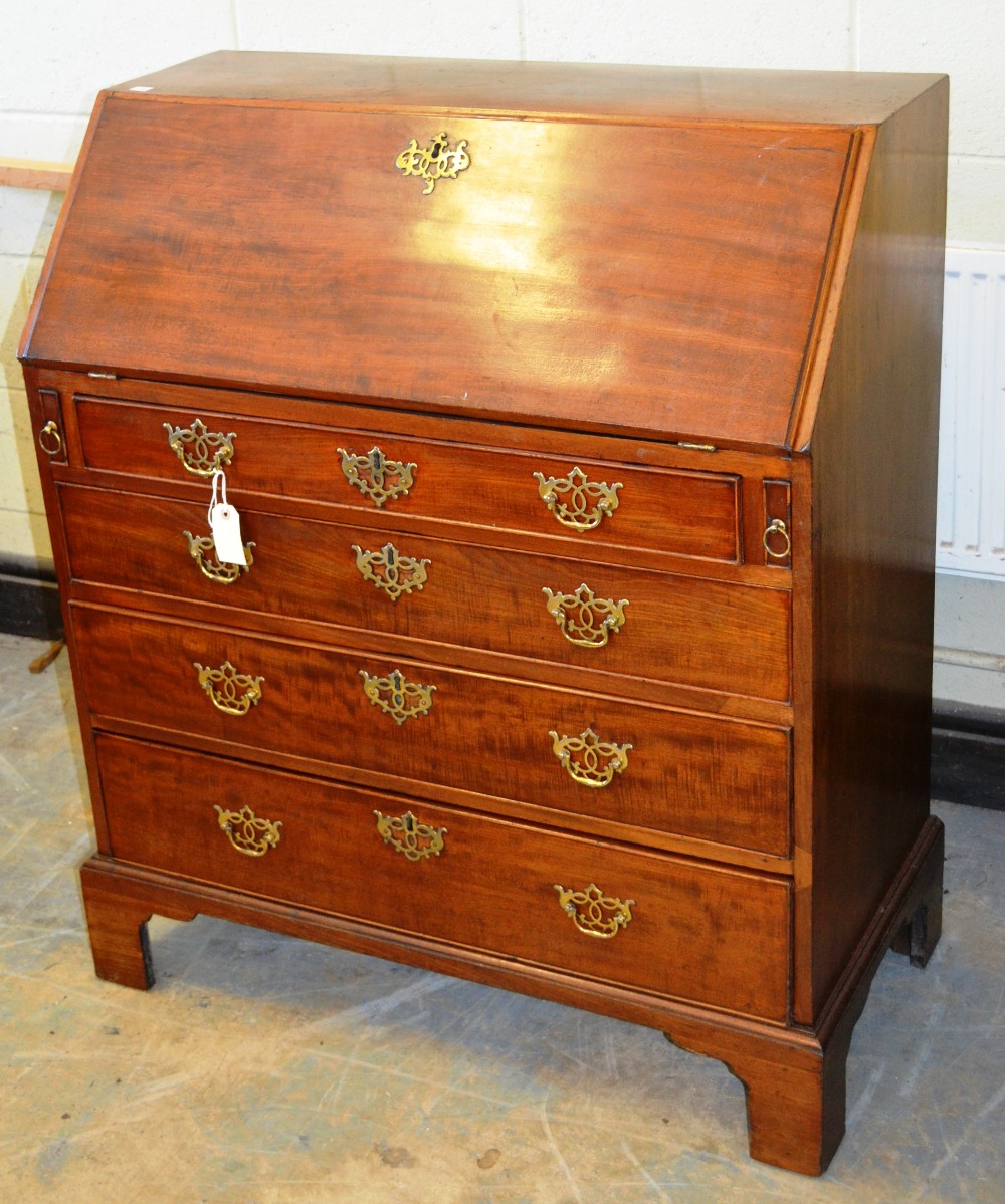 A mid eighteenth century mahogany bureau, the fall flop reveals a fitted interior with a cupboard