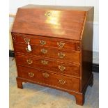 A mid eighteenth century mahogany bureau, the fall flop reveals a fitted interior with a cupboard