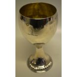 A George III silver wine goblet, the ovoid bowl engraved a crest and gilded inside, on a gadroon