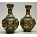 A pair of mid twentieth century Chinese enamel and gilt ground brass vases, decorated foliage, the