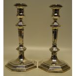 A pair of silver octagonal candlesticks, the baluster stems with campanula shape candleholders