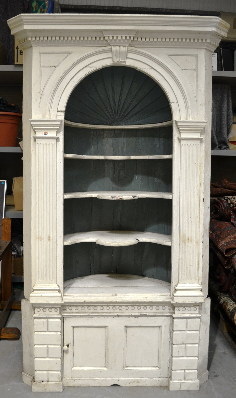 An eighteenth century painted pine corner display unit the moulded dentil cornice with a keystone