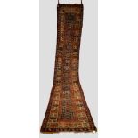 Kurdish runner with Karabakh borders, north west Persia, early 20th century 15ft. 8in. x 3ft. 2in.