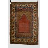 Ghiordes prayer rug, west Anatolia, early 20th century, 5ft. 4in. x 3ft. 8in. 1.63m. x 1.12m.