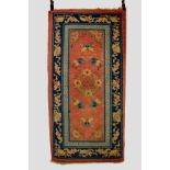 Suiyuan oval rug, north west China, early 20th century, 4ft. 11in. x 2ft. 6in. 1.50m. x 0.76m. And a