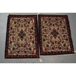 Two pairs of small north west Persian mats, 20th century; one pair with ivory fields; the other pair