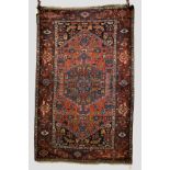 Hamadan rug with unusual all over ‘fish’ design on a red lozenge field with blue medallion and