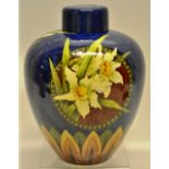 A late Victorian Doulton Lambeth Faience ware vase, decorated daffodils and foliage, panelled blue