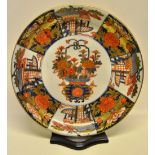 A nineteenth century Japanese porcelain Imari dish, decorated a red and gilt basket of flowers to