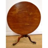 A mid eighteenth century Cuban mahogany tilt top centre table, the large one piece circular top on a