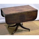 A Regency mahogany supper table, the rectangular well figured drop leaf top above a frieze drawer