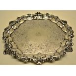 A William IV/ early Victorian silver salver, engraved a lion crest, foliage engraved surround, the