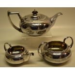 A Regency silver three piece tea service, the circular compressed bodies with a Greek key engraved