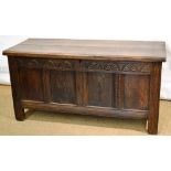 A seventeenth century oak coffer, the chip carved edge hinged lid above a quadruple panelled front