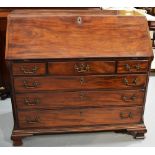 A George III Chippendale period mahogany bureau, the fall flap with a fitted interior, of a