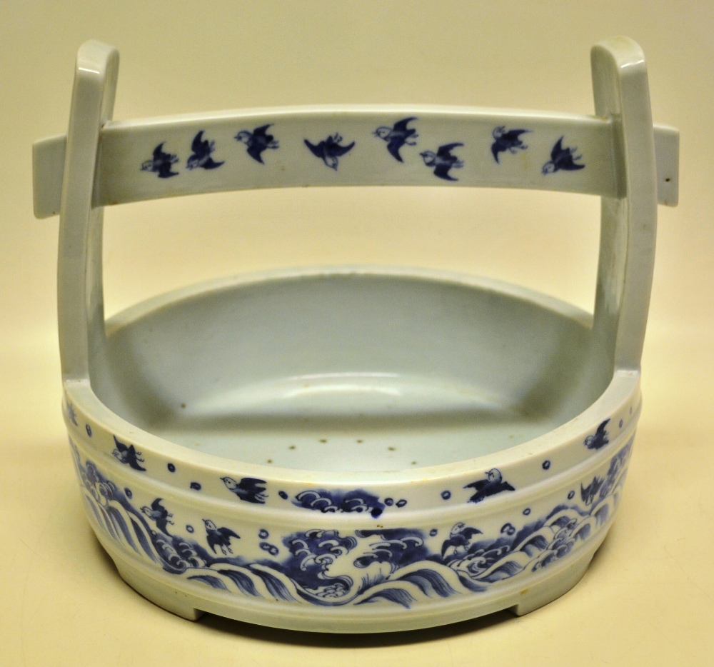 A large Japanese porcelain late nineteenth century rice carrier, with a temple gateway style handle,