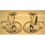 A pair of George III oval silver bedroom candlesticks, the candleholders with detachable nozzles and