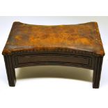 A late eighteenth century mahogany foot stool, covered nailed leather, the concave panel outline