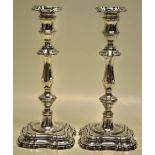 A large pair of Edwardian silver candlesticks, the spool shape candleholders with detachable