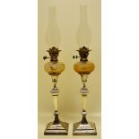 A pair of late Victorian electroplated candlestick oil lamps in neo classical style, the fluted