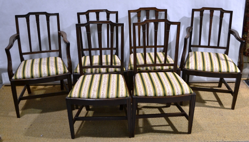 A set of six mahogany dining chairs of Sheraton design, the backs with capitals to the reeded