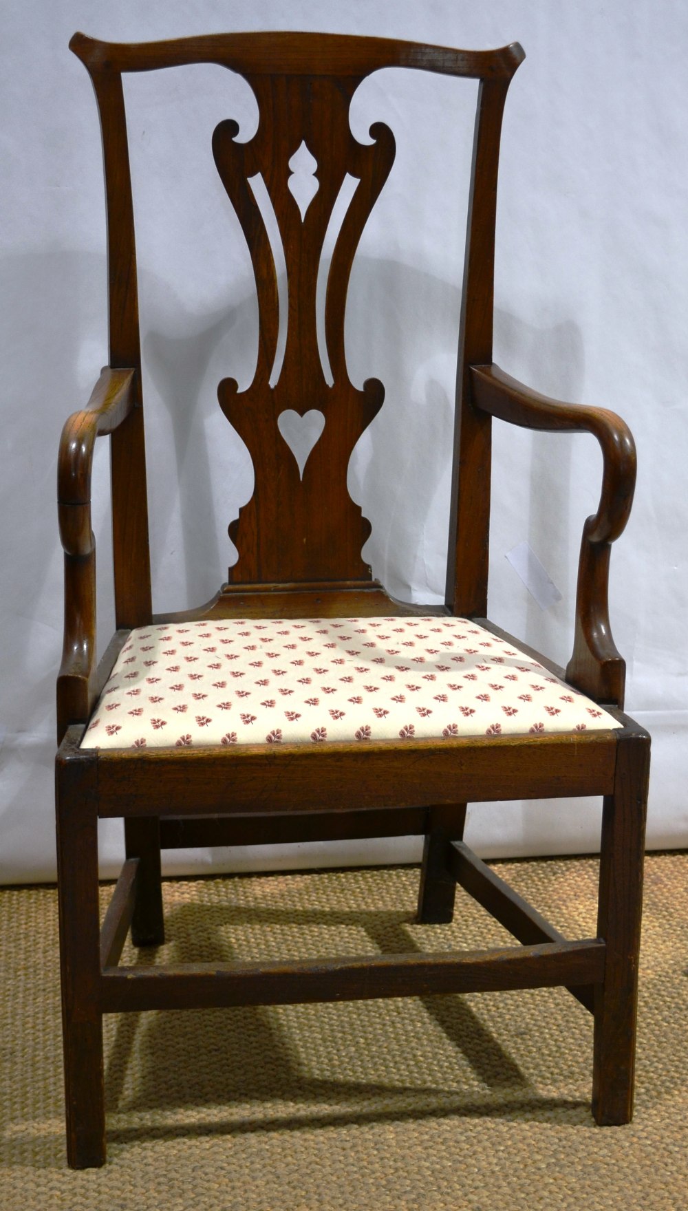 A late eighteenth century elm masters chair, with a high pierced splat back shepherd crook arms, a