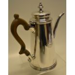A George II silver coffee pot, the tapering body engraved a later crest with motto, a facetted