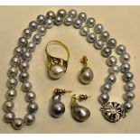 A single row silvery grey cultured pearls uniform size on floral snap stamped 925. Together with