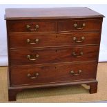 A late George III mahogany veneered chest, of 2 short and 3 long graduated drawers, the top