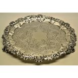 A George IV Scottish silver circular salver, the centre with a vacant cartouche borded with flat