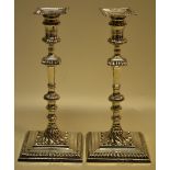 A pair of early George III silver cast candlesticks, with gadroon borders, the spool shape