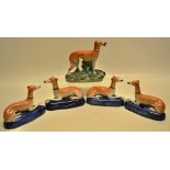 Two pairs of nineteenth century Staffordshire recumbent greyhounds on blue bases with gilt lines (