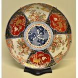 A late nineteenth century Japanese Imari porcelain charger the centre with blue and white linked