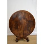 A William IV mahogany loo table, with well figured veneered circular tilt top on a facetted baluster