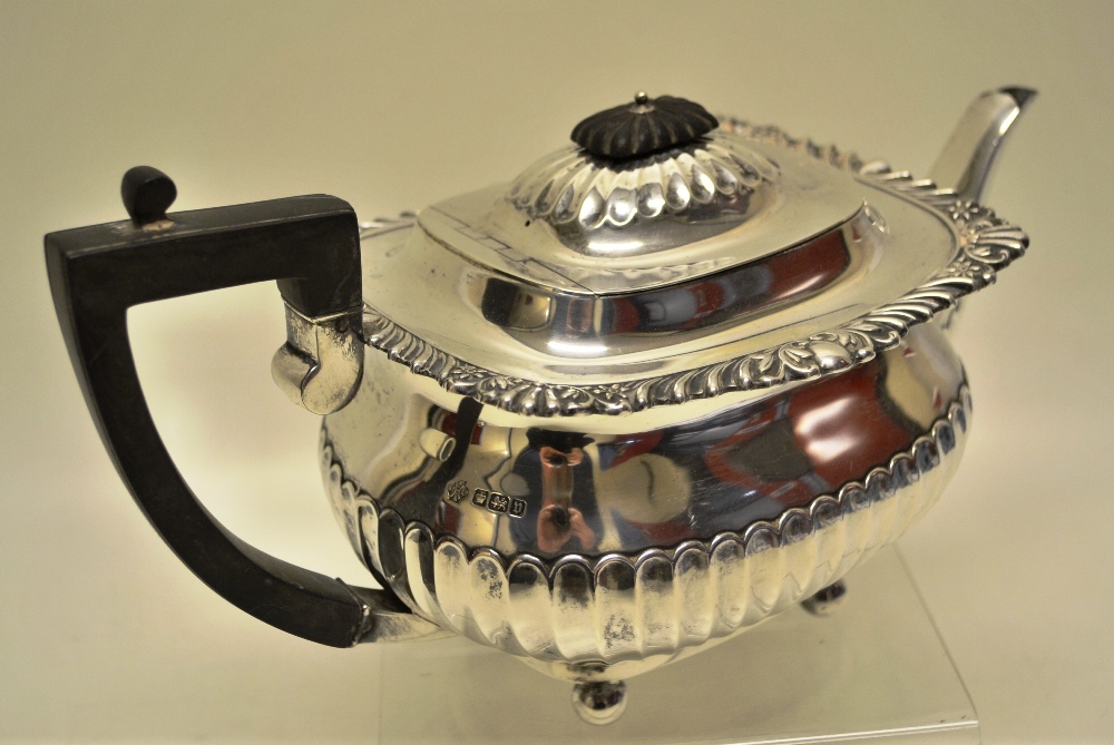 An Edwardian silver rectangular teapot, the ogee part fluted body with a part fluted spout,