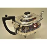 An Edwardian silver rectangular teapot, the ogee part fluted body with a part fluted spout,