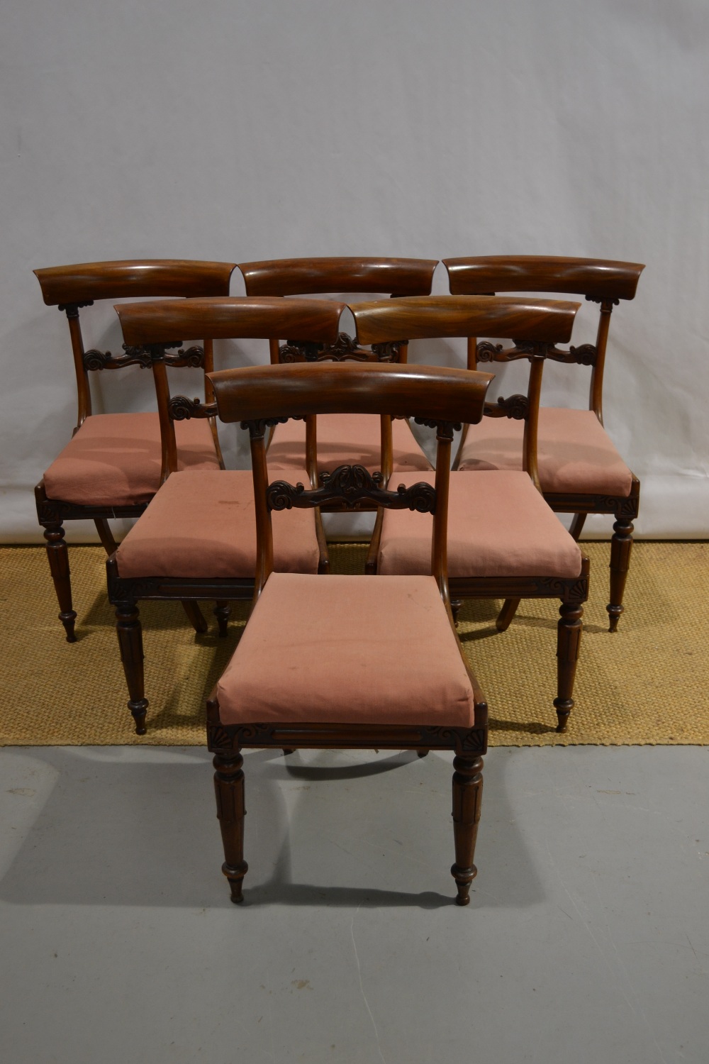 A set of six early Victorian mahogany side chairs, the backs with foliage carved rails and carved