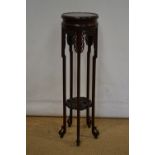 A Chinese hardwood jardinière stand, the circular top with pierced friezes, the legs supported by