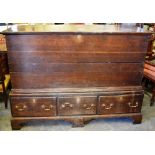 An eighteenth century oak blanket chest on stand, with a hinged lidded top (interior base board